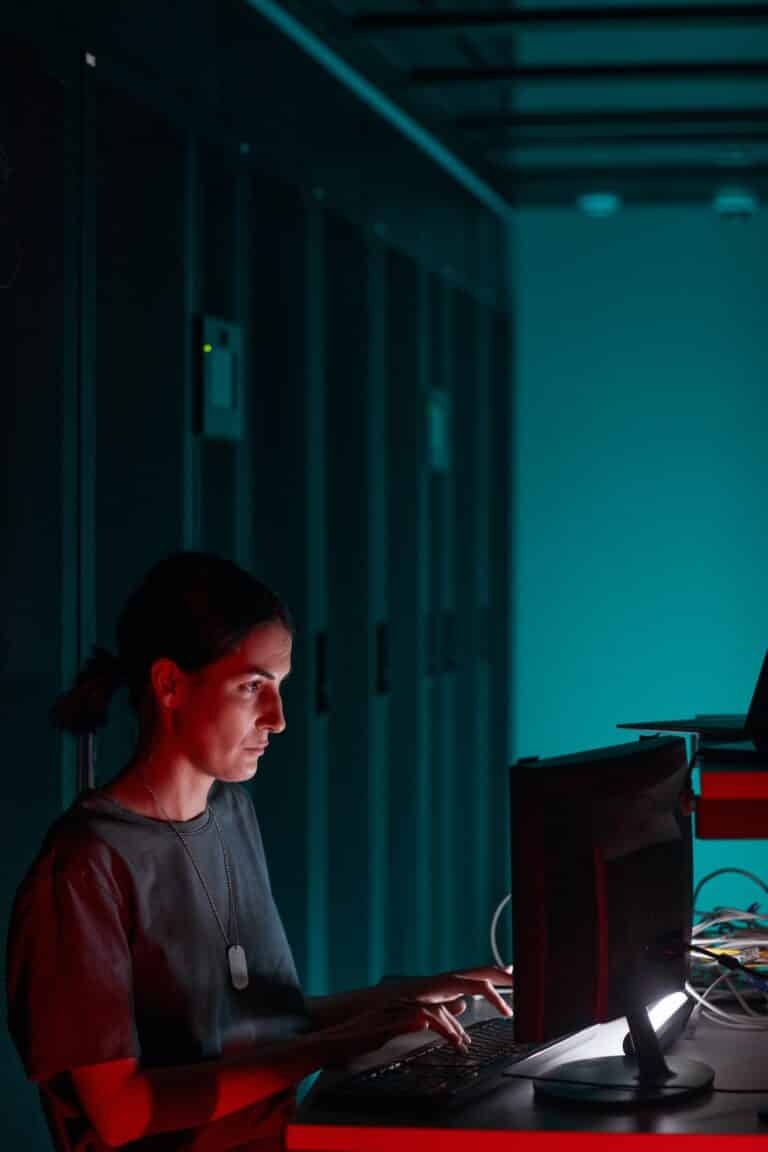 Woman using Computer in Data Center Side View